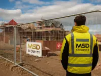 MSD SECURITY sign on fencing at a Northern Ireland construction site with active building in progress